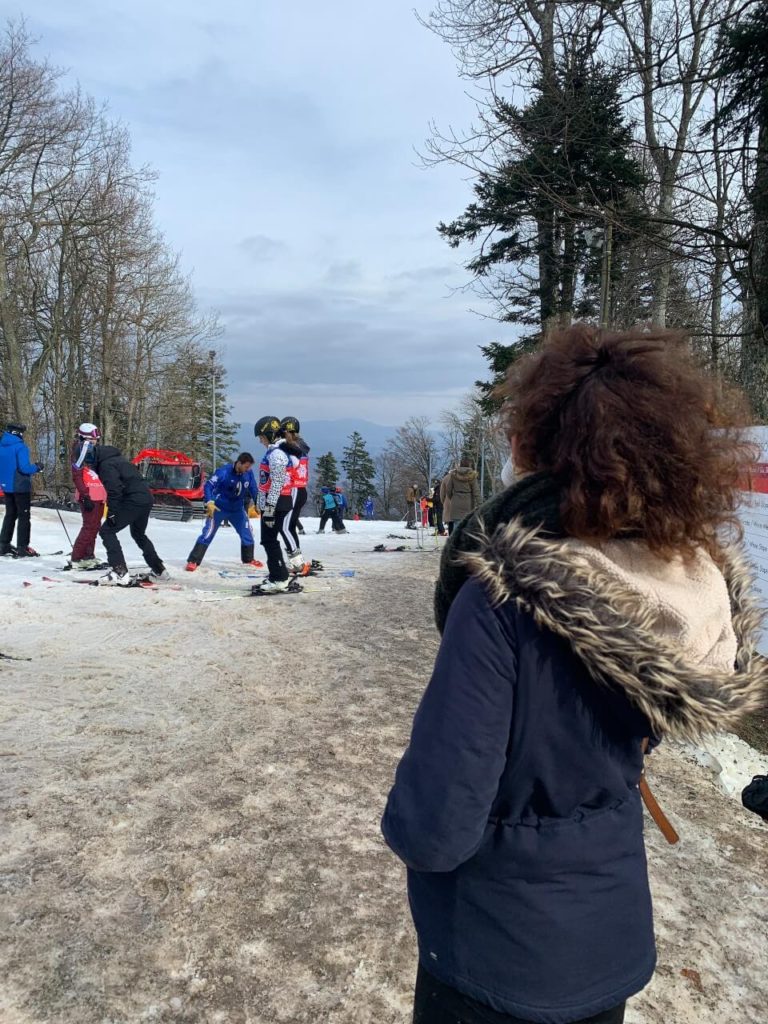 People skiing under a blue sky at Medvednica Mountain in Zagreb, Croatia.