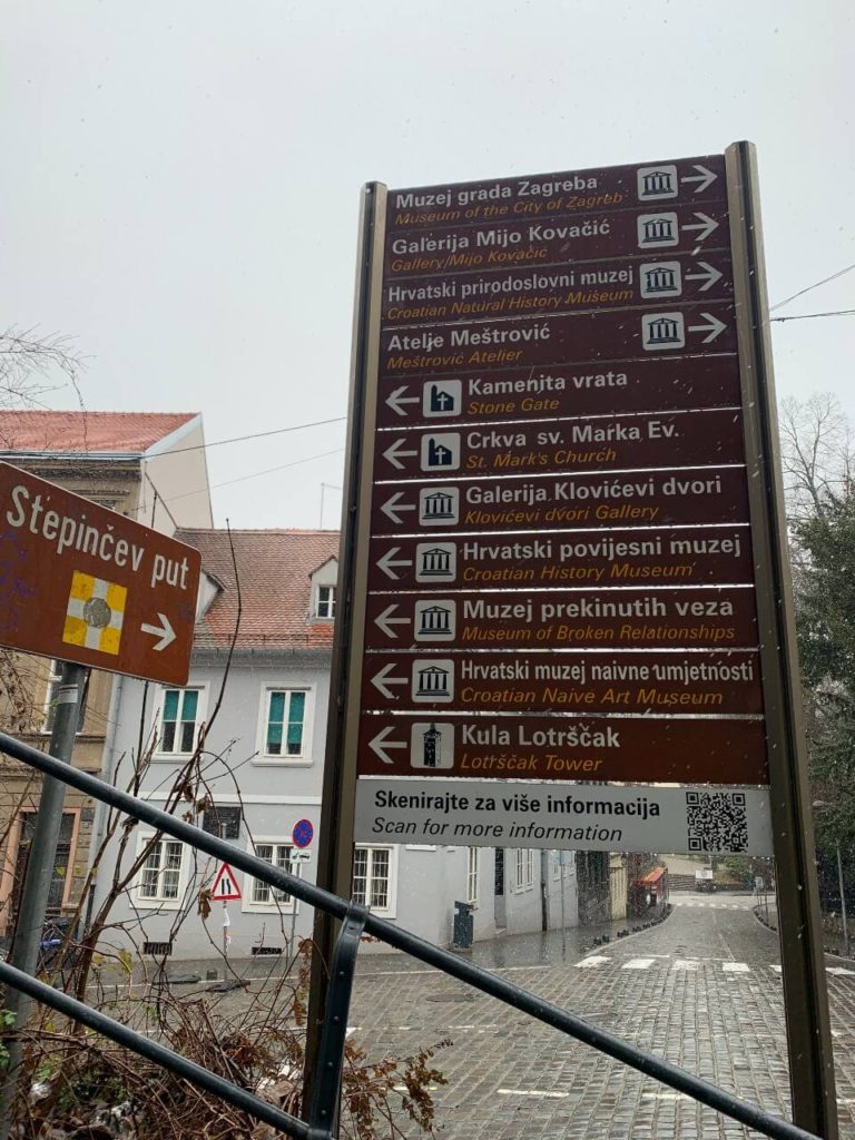 Tall and brown street sign in Zagreb, Croatia in the snow.